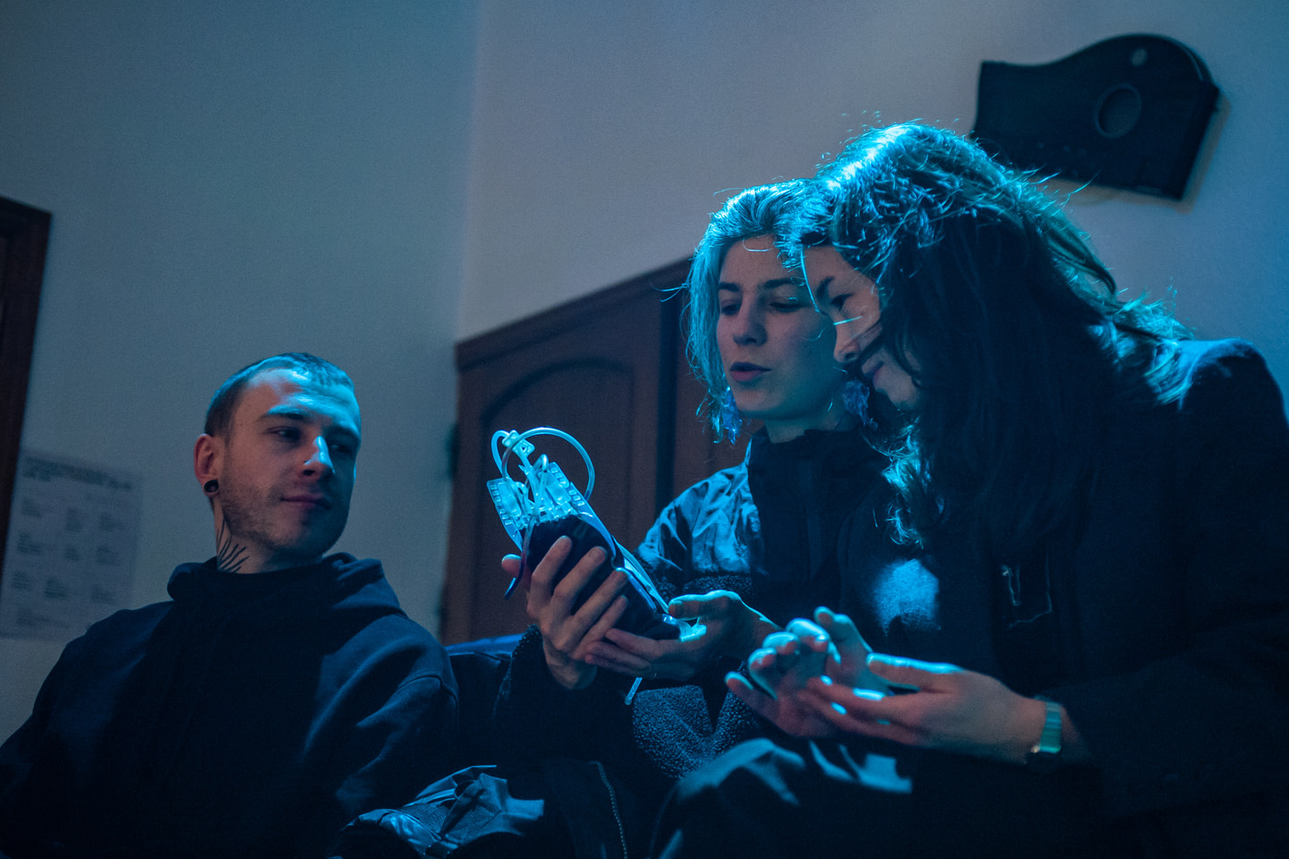 Participants during Kateryna Libkind's performance "Hook 1. Hold my bag" hold and examine a prop (a bag with Kateryna Libkind's blood)